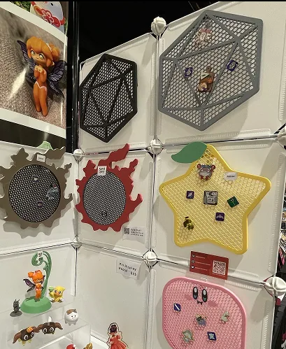Display wall with geometric shaped pin/figure boards at convention